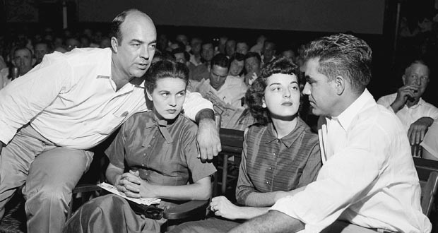 From left: J.W. Milam, an unindentified woman, Carolyn Bryant and Roy Bryant look toward Roy Bryant in front of a crowd in a courtroom