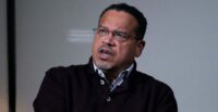 Keith Ellison answers a question during an interview in Boston