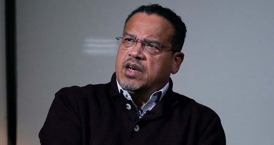 Keith Ellison answers a question during an interview in Boston