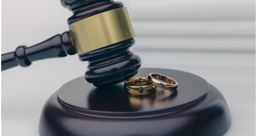 a gavel and judge's block with wedding rings on them