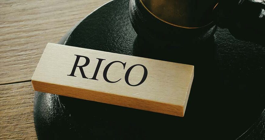 Word RICO on Wooden Block with Gavel and Sound Block Representing Organized Crime Legal Rulings