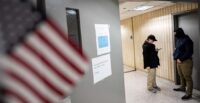 Federal immigration officers wait for respondents in a hallway to conduct targeted detainments at U.S. immigration court in New York City on Jan. 14, 2026