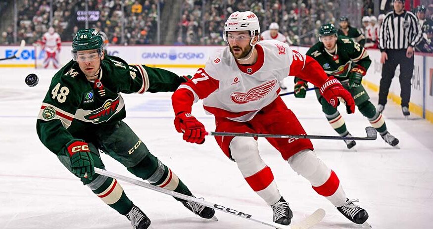 Daemon Hunt (48) and Michael Rasmussen (27) race after a loose puck