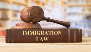 Immigration Law books with a judges gavel on desk in the library. Law education ,law books concept.