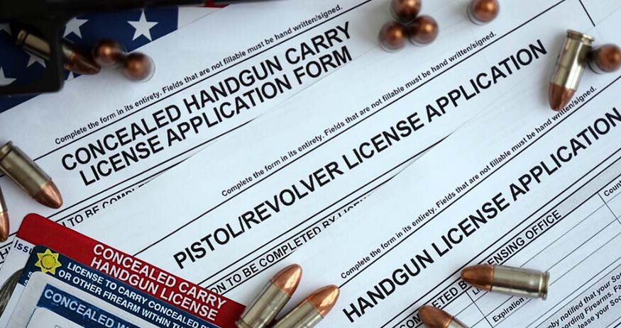 USA firearms license and handgun with bullets on US Constitution. Gun permit and Constitution second amendment concept