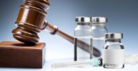Small vials with liquid in them next to a gavel