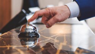 Hand of man using a hotel bell