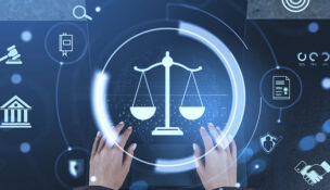 Hands typing on keyboard with glowing justice scale hologram and law-related icons on abstract dark background, concept of digital legal technology